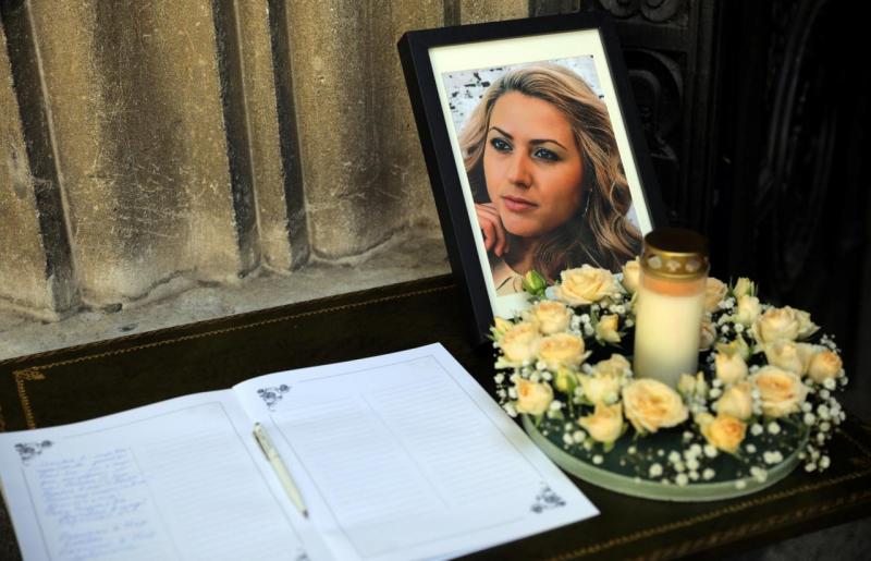The picture of killed Bulgarian journalist Viktoria Marinova and a condolence book are seen before her funeral service in Holy Trinity Cathedral in Ruse, Bulgaria, October 12, 2018. REUTERS