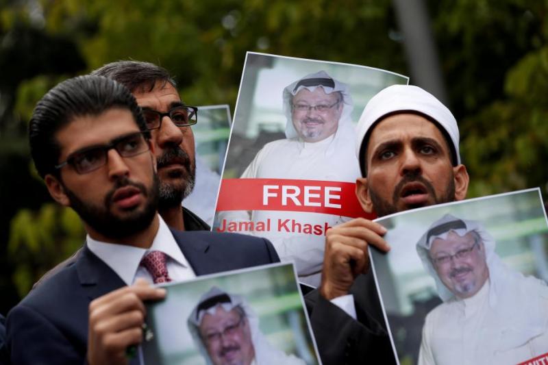 Human rights activists and friends of Saudi journalist Jamal Khashoggi hold his pictures during a protest outside the Saudi Consulate in Istanbul, Turkey October 8, 2018. REUTERS/FILE PHOTO