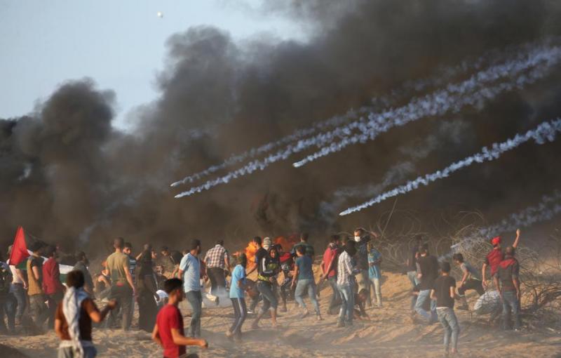 Tear gas canisters are fired by Israeli troops towards Palestinian demonstrators during a protest calling for lifting the Israeli blockade on Gaza and demanding the right to return to their homeland, at the Israel-Gaza border fence in the southern Gaza Strip October 12, 2018. REUTERS
