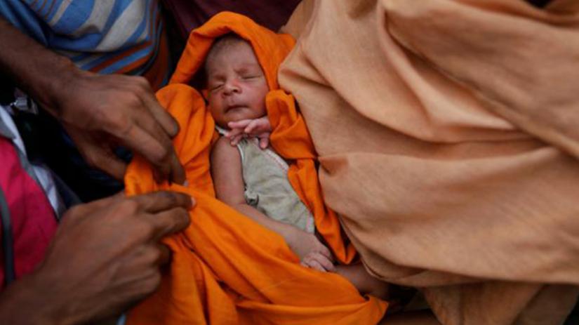 A doctor checks a three-day old baby as Rohingya refugees gather at a relief point for babies and pregnant women at the Kutupalang refugee camp in Cox’s Bazar, Bangladesh, Oct 2, 2017. REUTERS