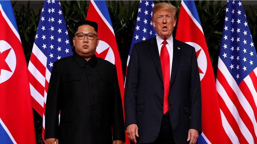 North Korea`s leader Kim Jong Un stands next to US President Donald Trump before their meeting at the Capella Hotel on Sentosa island in Singapore June 12, 2018. REUTERS
