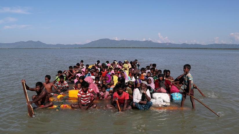 This November 2017 photo shows Rohingyas crossing the Naf River with an improvised raft to reach to Bangladesh at Sabrang near Teknaf, Bangladesh. REUTERS