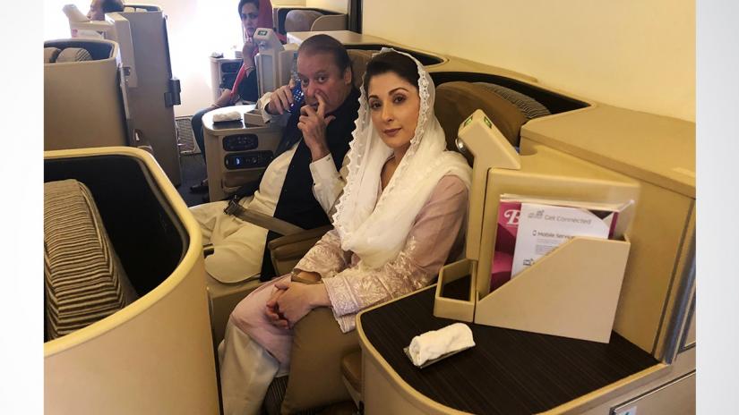 Ousted Pakistani Prime Minister Nawaz Sharif and his daughter Maryam sit on a Lahore-bound flight due for departure, at Abu Dhabi International Airport, UAE Jul 13, 2018. REUTERS