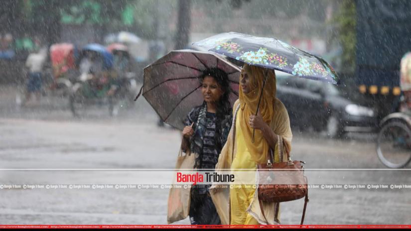 This undated file photo shows two girls are walking in the rain on a Dhaka street. PHOTO/Nashirul Islam