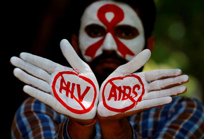 A student displays his hands painted with messages as he poses during an HIVAIDS awareness campaign to mark the International AIDS Candlelight Memorial, in Chandigarh, India, May 20, 2018. REUTERS/FILE PHOTO