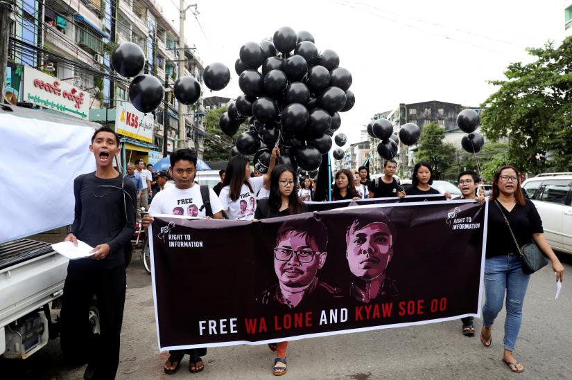 People march to show solidarity for jailed Reuters journalists Wa Lone and Kyaw Soe Oo two days before a local court is due to deliver verdict against them on charges of breaching the country`s Official Secrets Act in Yangon, Myanmar, September 1, 2018. REUTERS