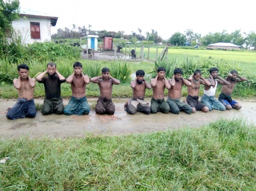 Ten Rohingya Muslim men with their hands bound kneel in Inn Din village September 1, 2017. Handout via REUTERS/File Photo