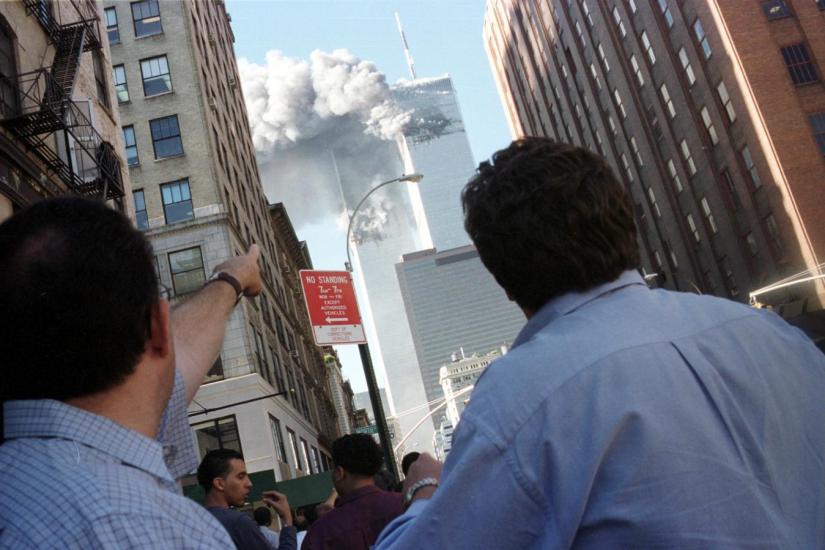 Pedestrians react to the World Trade Center collapse September 11, 2001. REUTERS