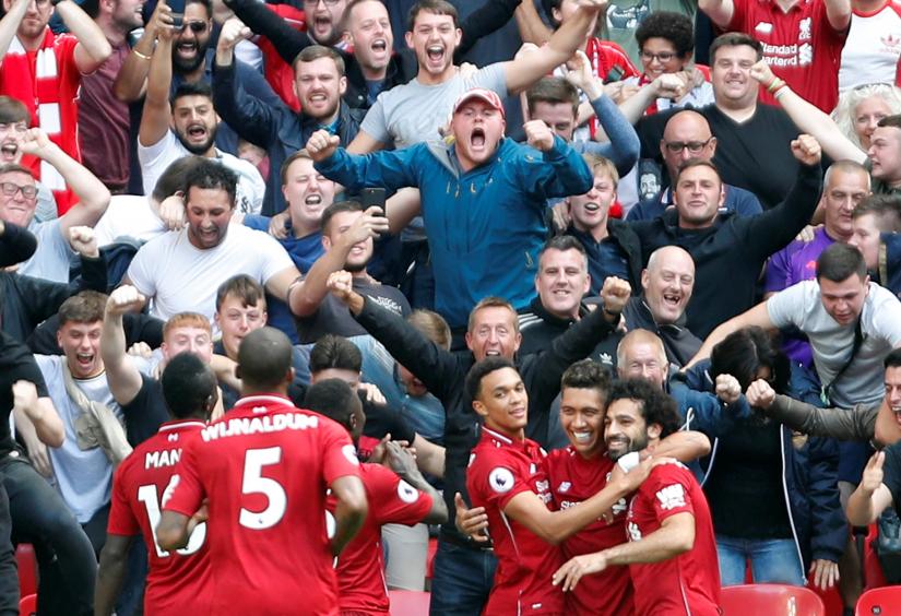 Liverpool`s Roberto Firmino celebrates scoring their second goal with teammates
