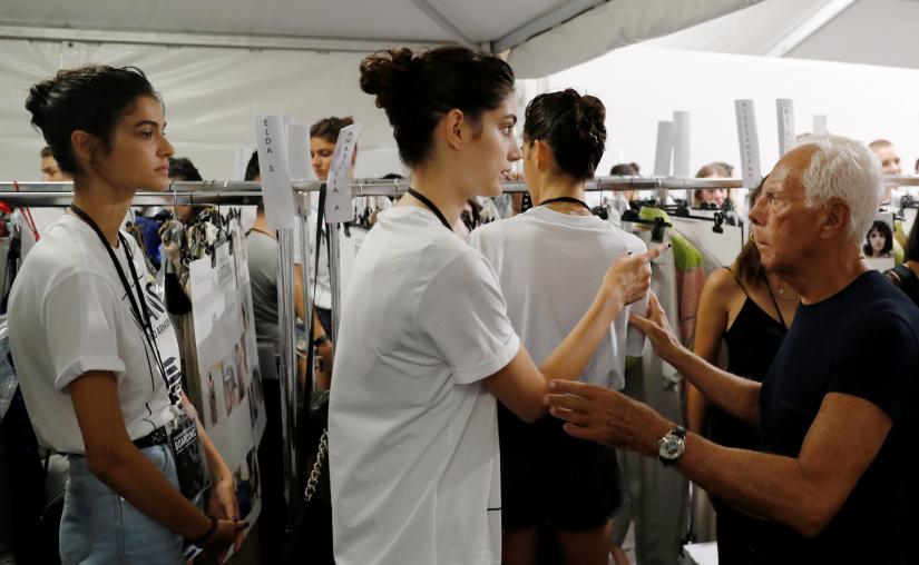 Italian designer Giorgio Armani talks with model at the backstage before the Emporio Armani show  2018 REUTERS