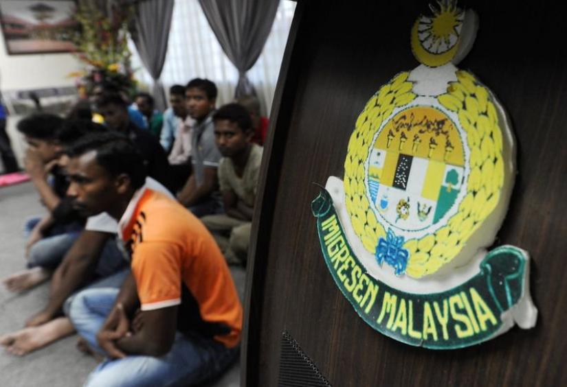 According to Malaysian law, workers can be detained and have their permits revoked if they were working at a place not referred to in their permit. File photo