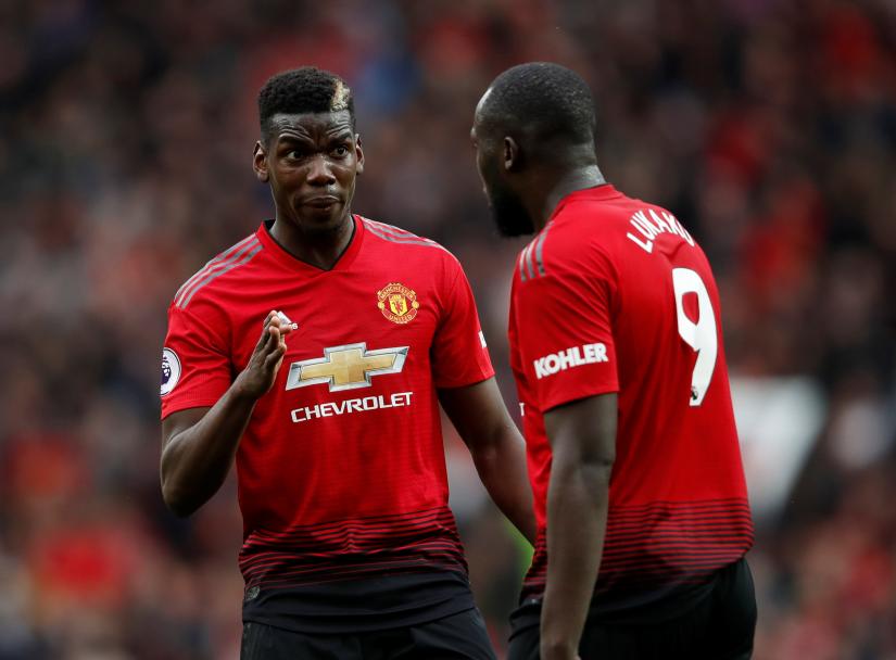 Manchester United`s Paul Pogba speaks with Romelu Lukaku. Reuters