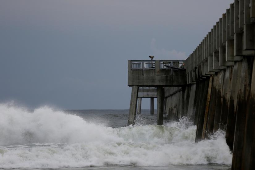 Waves crash along a pier as Hurricane Michael approaches Panama City Beach, Florida, U.S. October 9, 2018. REUTERS