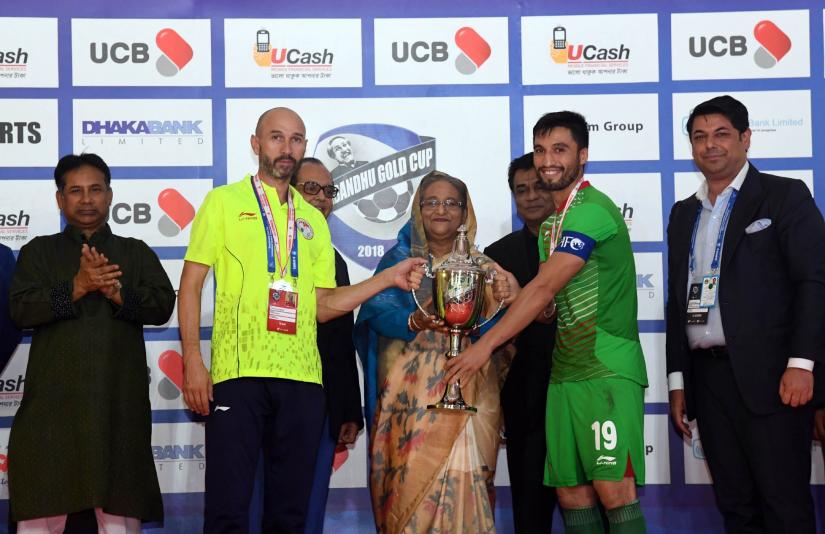 Prime Minister Sheikh Hasina hands over runners-up trophy of Bangabandhu International Gold Cup Football tournament to Tajikistan captain in Dhaka’s Bangabandhu National Stadium on Friday (Oct 12). PID