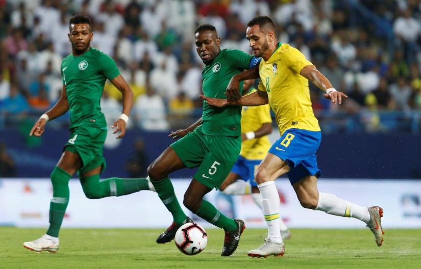 Saudi Arabia`s Omar Hawsawi in action with Brazil`s Renato Augusto during an international friendly  in King Saud University Stadium, Riyadh, Saudi Arabia, Oct 12. REUTERS