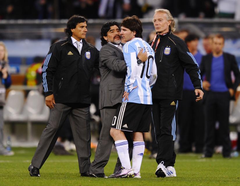 FILE PHOTO - Germany v Argentina FIFA World Cup Quarter Final - South Africa 2010 - Green Point Stadium, Cape Town, South Africa - 3/7/10  Argentina coach Diego Maradona and Lionel Messi (R) look dejected at the end of the match after failing to reach the semi final. REUTERS