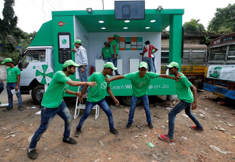 WhatsApp-Reliance Jio representatives perform in a street play during a drive by the two companies to educate users, on the outskirts of Kolkata on Aug 14