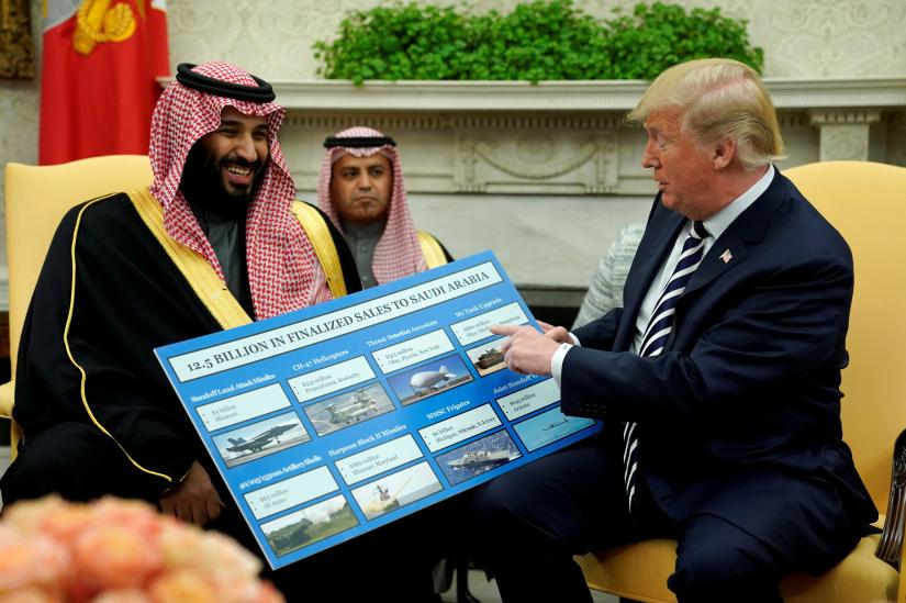 U.S. President Donald Trump holds a chart of military hardware sales as he welcomes Saudi Arabia`s Crown Prince Mohammed bin Salman in the Oval Office at the White House in Washington, U.S., March 20, 2018. REUTERS