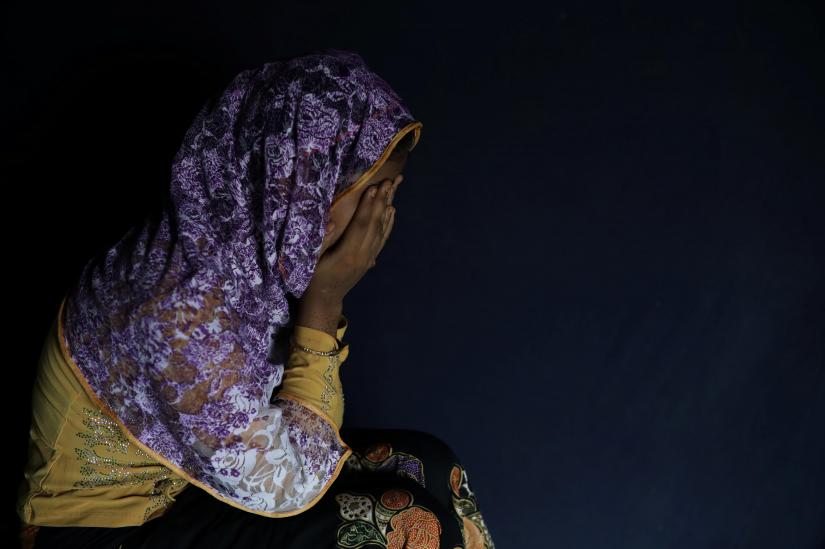 A Rohingya woman hides her face in Teknaf, Bangladesh, June 25, 2018. REUTERS/
