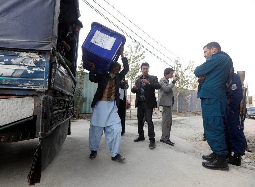 Afghan election commission unloads a ballot box with election material outside a polling station in Kabul, Afghanistan Oct 19. REUTERS