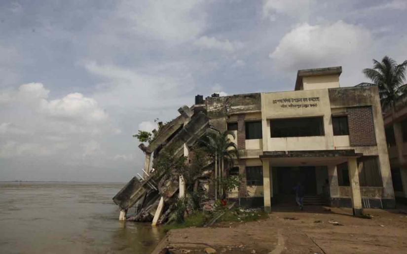 This file photo shows the Naria Upazila Health Complex in Shariatpur falls into the Padma River due to erosion of the riverbank on August, 2018.