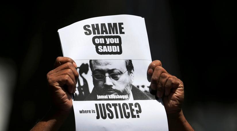 A member of Sri Lankan web journalist association holds a placard during a protest condemning the murder of slain journalist Jamal Khashoggi in front of the Saudi Embassy in Colombo, Sri Lanka October 25, 2018. REUTERS