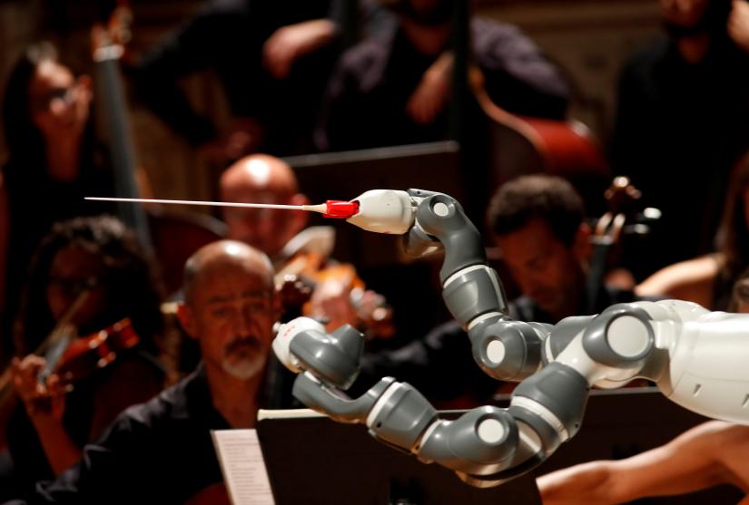 Humanoid robot YuMi conducts the Lucca Philharmonic Orchestra performing a concert alongside Italian tenor Andrea Bocelli (unseen) at the Verdi Theatre in Pisa, Italy September 12, 2017. REUTERS/file photo