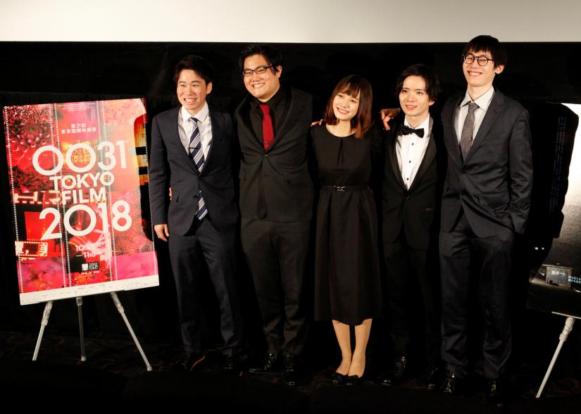 Director Kensei Takahashi (R) and cast members from 'Sea', Seijyuro Mimori, Arisa Sato and Satoshi Abe and producer Taichi Tamura (L) attend a post-screening Q&A session after the film's world premiere at the 31st Tokyo International Film Festival in Tokyo, Japan, October 27, 2018. Picture taken October 27, 2018. REUTERS