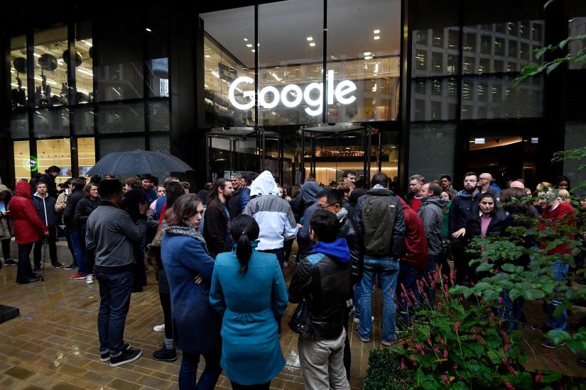 Workers stand outside the Google offices after walking out as part of a global protest over workplace issues, in London, Britain, November 1, 2018. REUTERS/