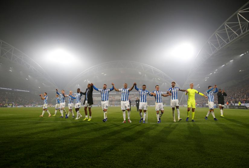 Huddersfield players salute their fans as they celebrate after the match on November 5,2018. Action Images via Reuters