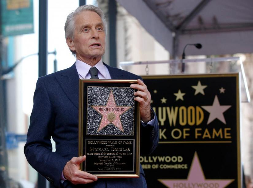 Actor Michael Douglas poses during the unveiling of his star on the Hollywood Walk of Fame in Los Angeles, California, U.S., November 6, 2018. REUTERS