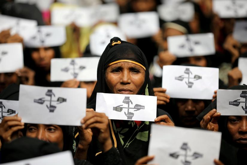 Rohingya refugee women hold placards as they take part in a protest at the Kutupalong refugee camp to mark the one-year anniversary of their exodus in Cox`s Bazar, Bangladesh, August 25, 2018. REUTERS FILE PHOTO