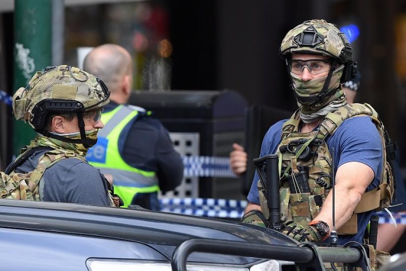 Armed security personnel stand near the Bourke Street mall in central Melbourne, Australia, November 9, 2018. AAP/via REUTERS