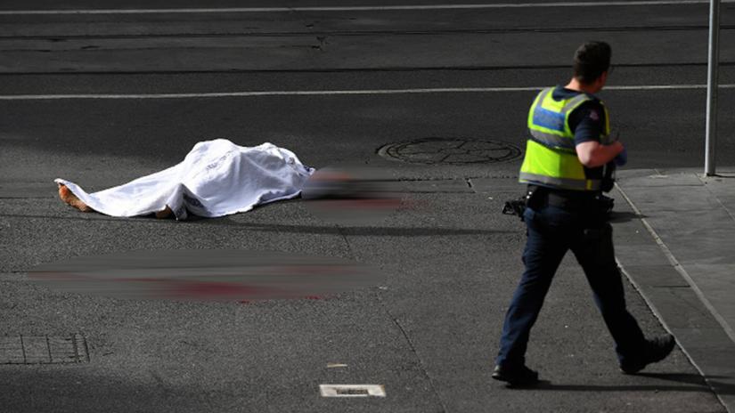 A body covered with a sheet near the Bourke Street mall in central Melbourne, Australia, November 9, 2018. AAP/via REUTERS