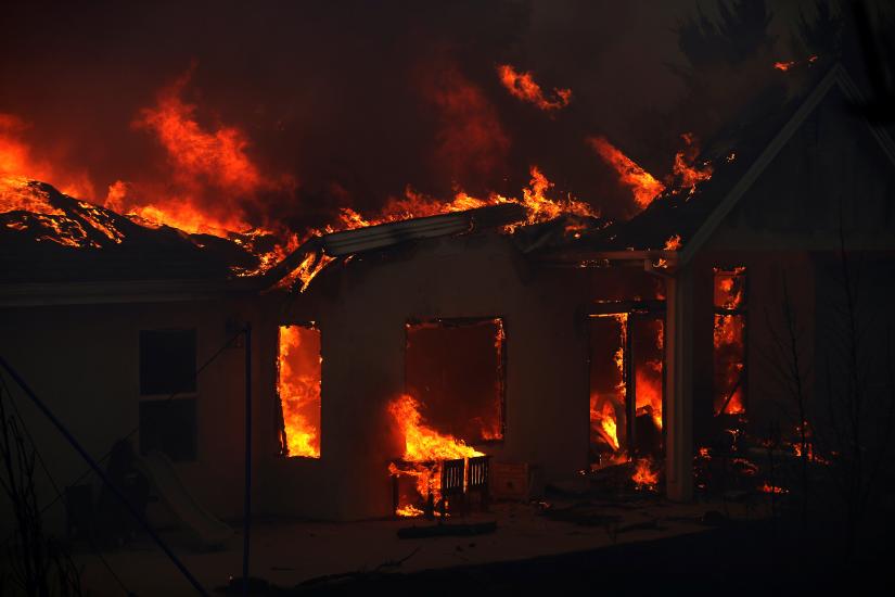 A home is engulfed in flames during the Camp Fire in Paradise, California, U.S. November 8, 2018. REUTERS