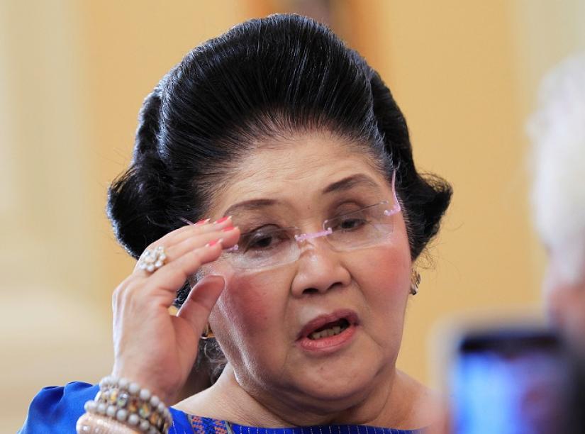 Former Philippine first lady Imelda Marcos, who is now a congresswoman, adjusts her glasses after attending the first Mass of the newly built Santuario de San Ezekiel Moreno Catholic church in Las Pinas city, south of Manila, August 19, 2014. REUTERS/FILE PHOTO