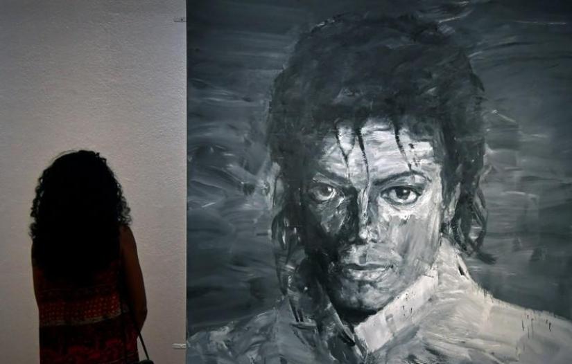 A visitor views `In Memory of Michael Jackson 1958-2009` by Yan Pei-Ming which forms part of the exhibition `Michael Jackson: On The Wall` showing until October 21 at the National Portrait Gallery in London, Britain, June 28, 2018. REUTERS