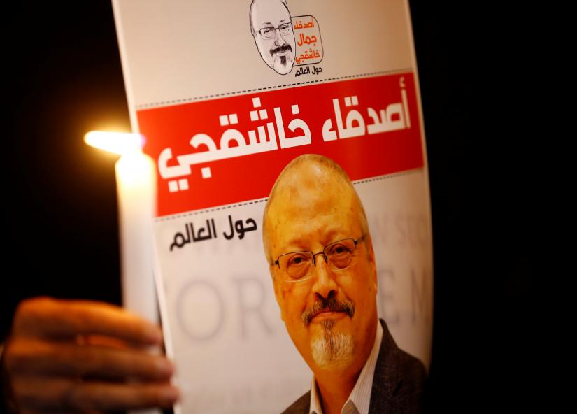 A demonstrator holds a poster with a picture of Saudi journalist Jamal Khashoggi outside the Saudi Arabia consulate in Istanbul, Turkey October 25, 2018. REUTERS FILE PHOTO