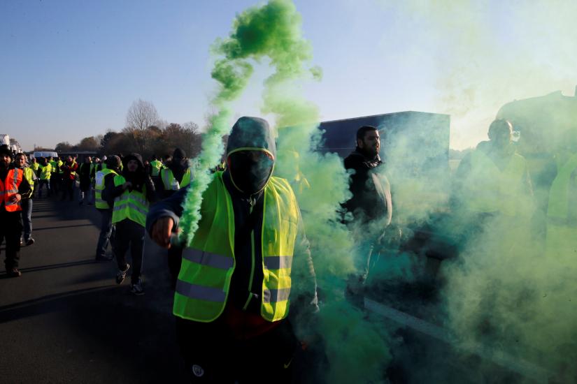 People wearing yellow vests, a symbol of French drivers` nationwide protest against higher fuel prices, block the Paris-Brussels motorway in Haulchin, France, November 17, 2018. REUTERS