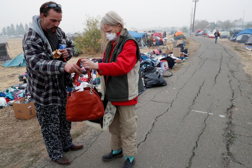 Travis Lee Hogan, of Paradise, talks with his mother, Bridgett Hogan, while they stay at a makeshift evacuation center for people displaced by the Camp Fire in Chico, California, US, November 15, 2018. REUTERS