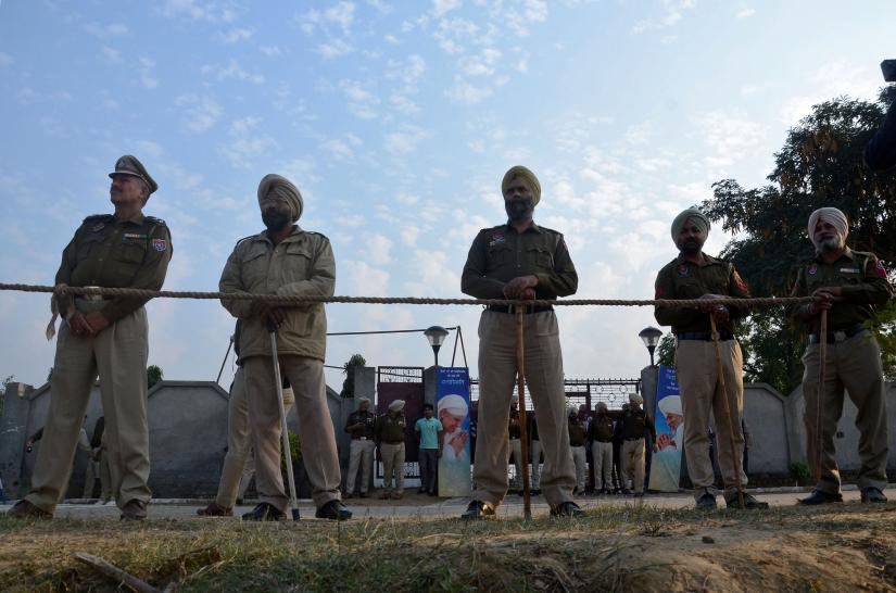 Police stand guard after a grenade blast outside a Sikh religious gathering site on the outskirts of Amritsar, India, November 18, 2018. REUTERS
