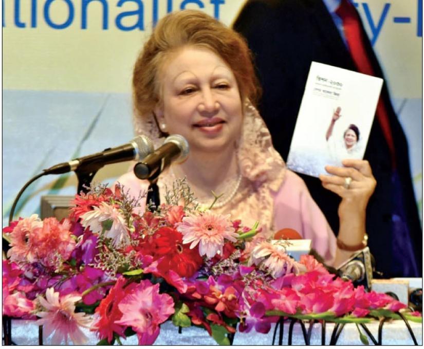 File photo shows BNP Chairperson Khaleda Zia holds a copy of the party’s “Vision 2030” at a Dhaka hotel on May 10, 2017.