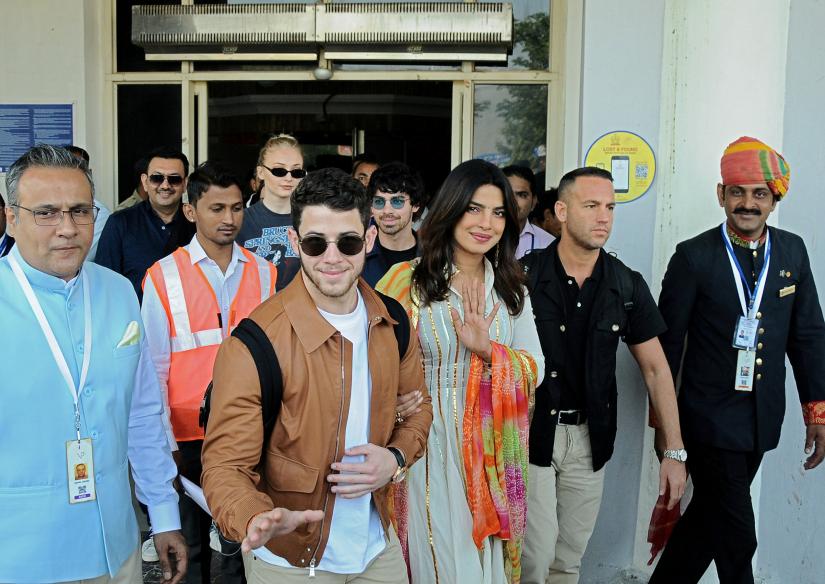 Bollywood actress Priyanka Chopra and singer Nick Jonas wave as they arrive at the airport in Jodhpur in the desert state of Rajasthan, India, November 29, 2018. REUTERS/FILE PHOTO