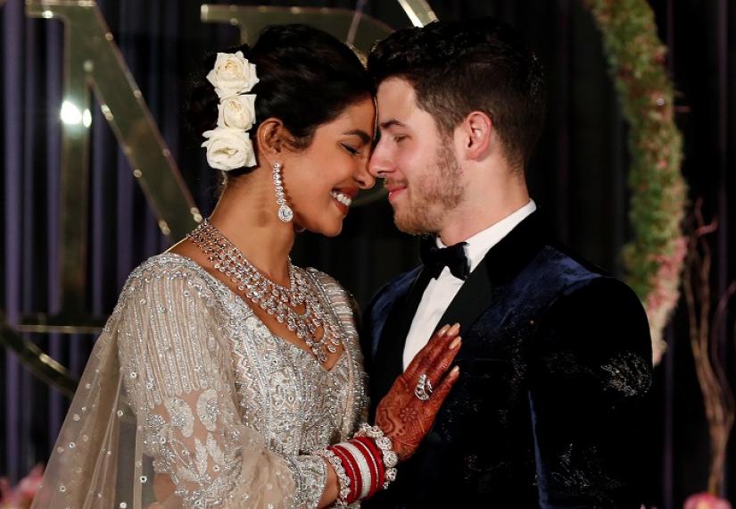 Bollywood actress Priyanka Chopra and her husband singer Nick Jonas pose during a photo opportunity at their wedding reception in New Delhi, India December 4, 2018. REUTERS