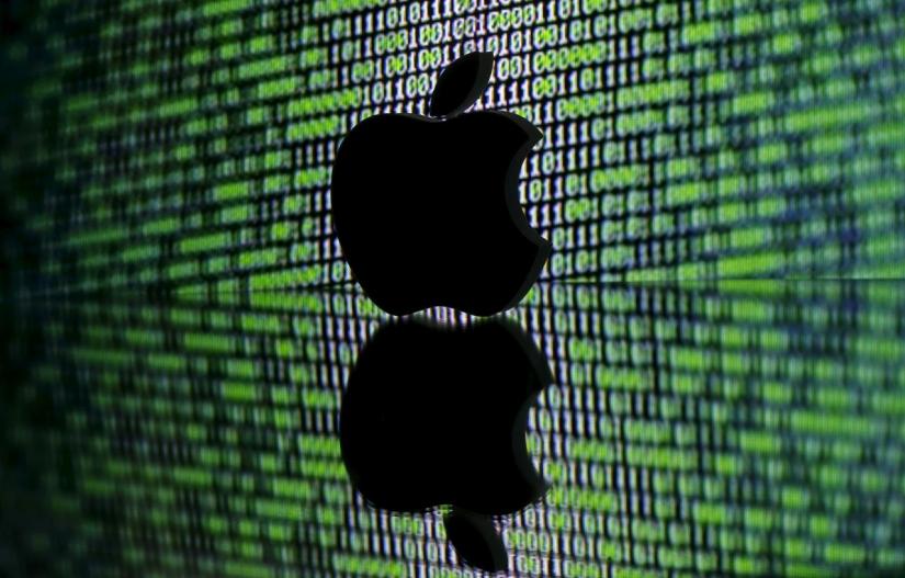 A 3D printed Apple logo is seen in front of a displayed cyber code in this illustration taken March 22, 2016. REUTERS/FILE PHOTO