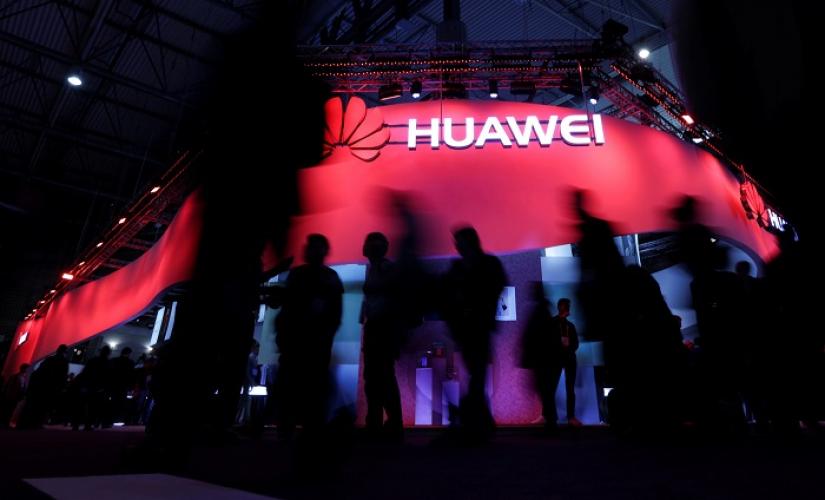 Visitors walk past Huawei`s booth during Mobile World Congress in Barcelona, Spain, February 27, 2017. REUTERS/FILE PHOTO