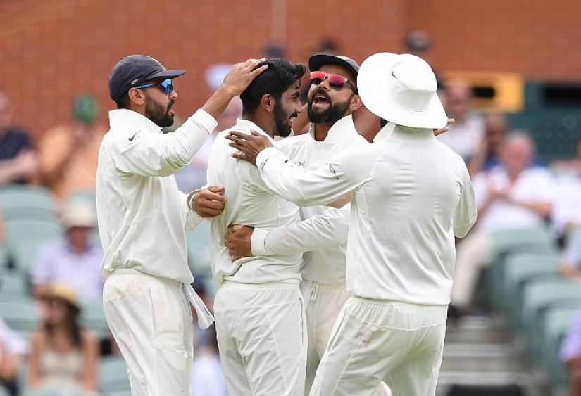 India`s captain Virat Kohli (2nd R) celebrates with his teammate Jasprit Bumrah (2nd L) after Bumrah dismissed Australian batsman Peter Handscomb for 34 runs on day two of the first test match between Australia and India at the Adelaide Oval in Adelaide, Australia, December 7, 2018. AAP/Dave Hunt/via REUTERS