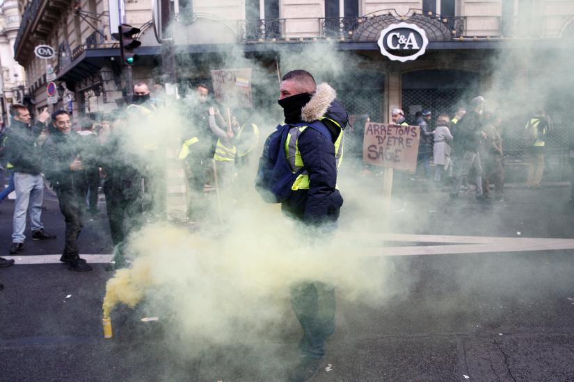 A protester wearing a yellow vest attends a demonstration during a national day of protest by the `yellow vests` movement in Paris, France, December 8, 2018. REUTERS