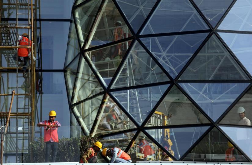 Construction workers install glass on the exterior of Gulita, a bungalow which according to local media will be the marital home of Isha Ambani, daughter of the Chairman of Reliance Industries Mukesh Ambani, in Mumbai, India, December 7, 2018. REUTERS