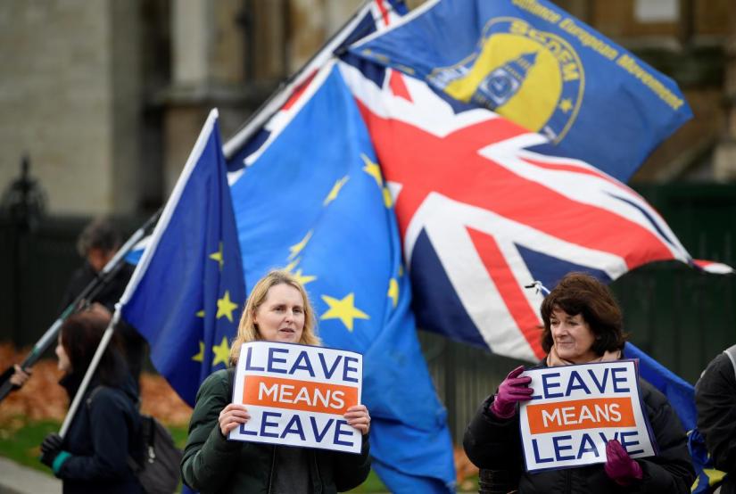 Pro-Brexit and anti-Brexit protesters hold posters and flags in Whitehall, in central London, Britain December 6, 2018. REUTERS